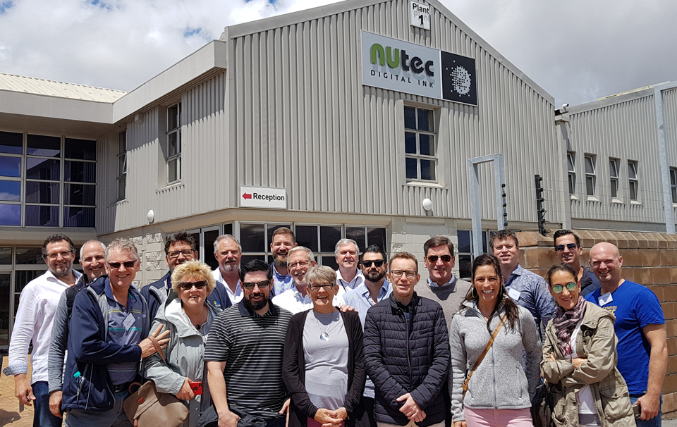 Group photo outside NUtec Digital Ink facility during GIGA event, showcasing digital printing ink manufacturer participation