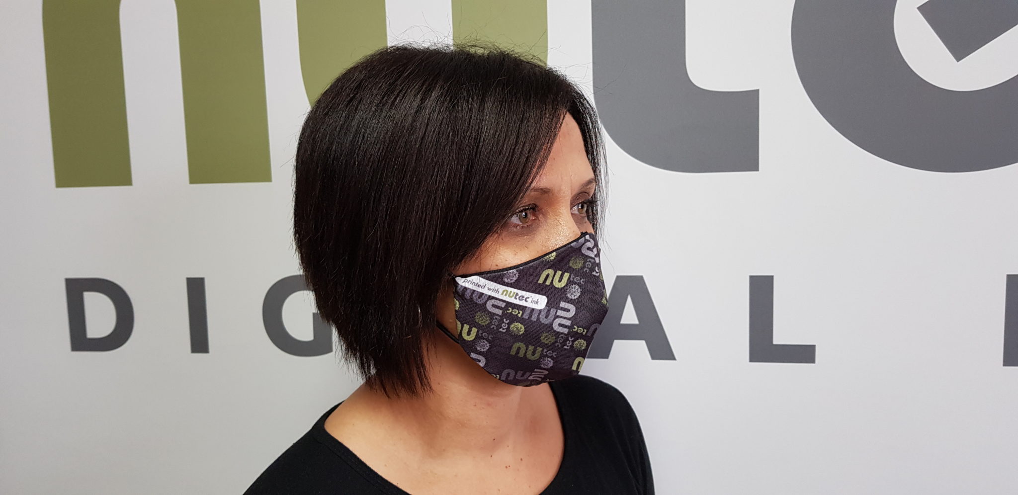 NUtec digital printing ink for dye sublimation used in colorful cloth masks, as shown on a model wearing a mask with NUtec branding.