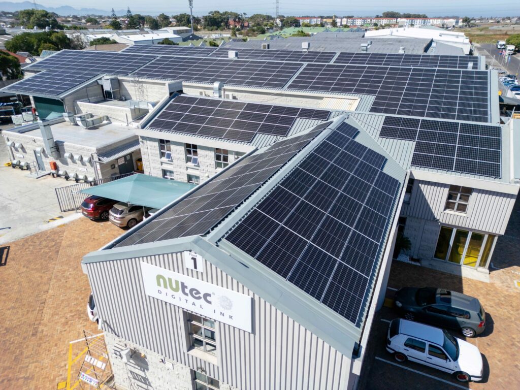 Roof with multiple solar panels installed on NUtec Digital Ink's facility for clean energy production, demonstrating sustainable digital printing solutions.