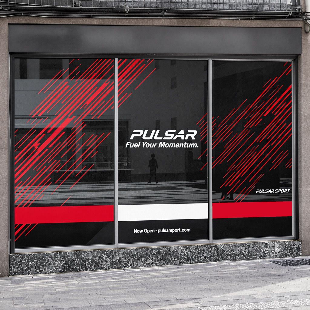 Pulsar Sport store window with red diagonal lines and 'Fuel Your Momentum' text, showcasing calendared vinyl graphics.