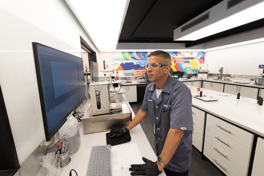 NUtec Digital Ink technician inspecting digital printing ink formulations in a modern laboratory
