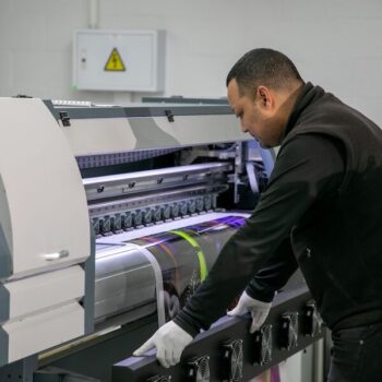 Technician performing printer conversion on large digital printing ink machine at NUtec Digital Ink facility